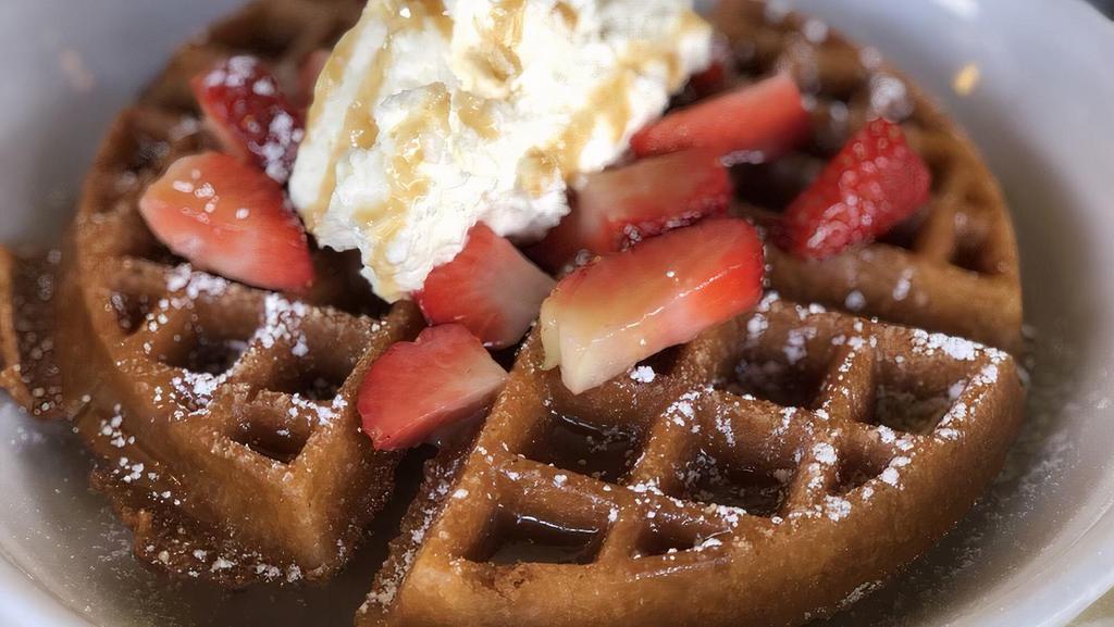 Churro Waffle · buttermilk waffle churro-style topped with homemade whipped cream, strawberries and caramel drizzle