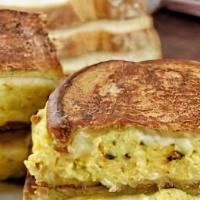 French Toast Biscuit Sandwich · 2 jumbo biscuit halves dipped and griddled til golden brown. Topped with  scrambled eggs, ch...