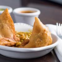 Samosa Chat · Two golden fried dumplings stuffed with spicy potatoes.