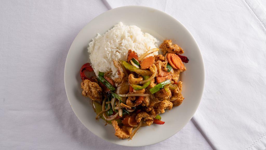 Crispy Cashew Nut Chicken · Sautéed deep-fried chicken with bell peppers, white onions carrots, green onions, cashew nuts, and chili paste over steamed rice.