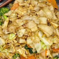 Pad See Ew · Stir-fried flat rice noodles with egg, broccoli, carrots, and cabbages in sweet black soy sa...