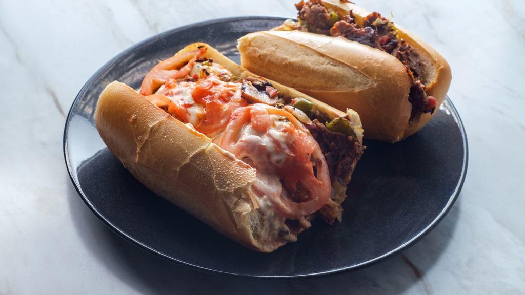 Buffalo Chicken Philly Cheesesteak · Chicken Philly cheesesteak with tender, chopped, grilled chicken, your choice of melty cheese, grilled onions, and peppers and a drizzle of spicy Buffalo sauce on a French roll.