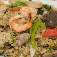 Combo Basil Fried Rice · with chicken, beef, pork, prawns, imitation crab, egg, onion, peas, carrots, basil, and Thai...
