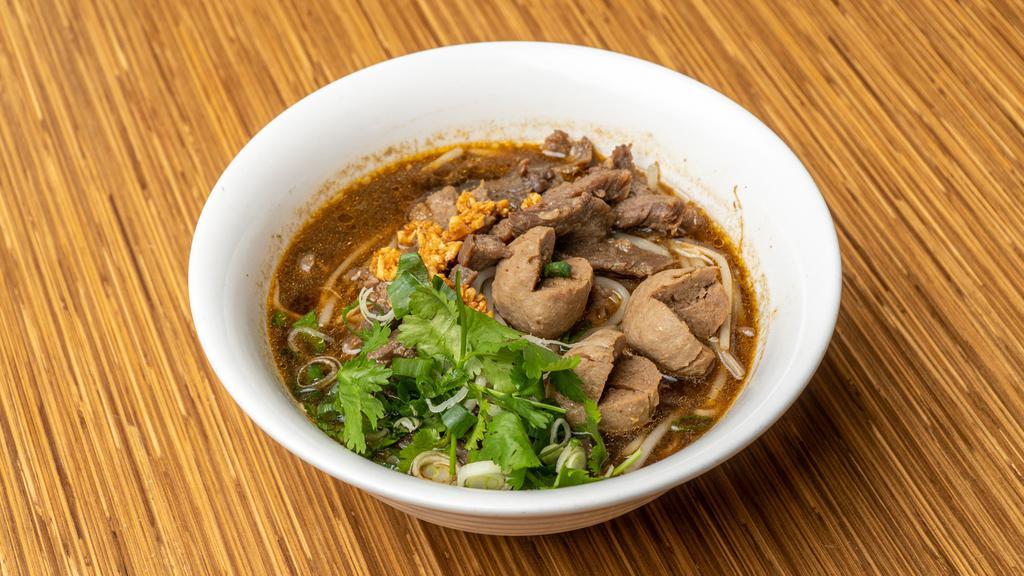 Thai Boat Noodle Soup · Thai herbal beef broth with Thai vermicelli rice noodles, sliced beef, beef balls, bean sprouts, topped with fried garlic, green onion and cilantro.