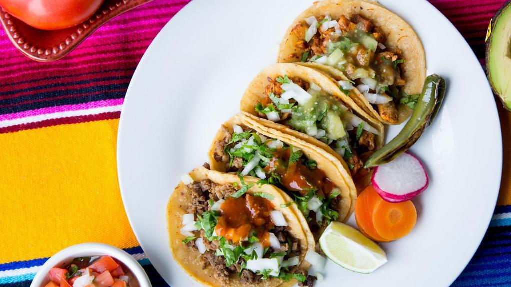 Four Street Tacos · Gluten free. Dairy free. Locally made corn tortillas with your choice of meat, diced onions, cilantro and hot or mild salsa.