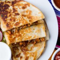 Quesadillas · Locally made tortilla, choice of meat, served with a side of lettuce, pico de gallo and sour...