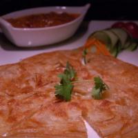 #5 Roti · Indian roti served with peanut curry sauce.
