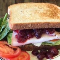 Turkey Cranberry Sandwich · Cranberry sauce, cream cheese, lettuce, tomato, and spinach. With Bagel, Bread, Baguette, En...