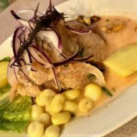 Ceviche de Pescado · Red snapper marinated with lemon juice and Peruvian spices served with sweet potatoes, Peruv...