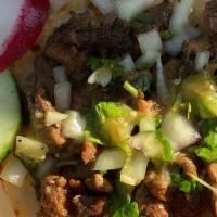 Tacos de asada · Con cebolla y  cilantro y salsa roja o vere

Comes with onion and cilantro and red or green ...