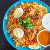 Chicken Biriyani · Served with Raita and Spicy Salan. 4 pieces of chicken