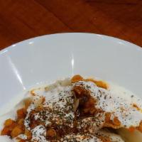 Manto · Large ravioli pockets (with ground beef and onion fillings). Topped with yogurt, lentil (red...