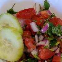 Salata · Chopped tomatoes, onions, cilantro, lettuce and cucumber.
