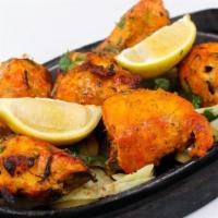 Tandoori Chicken · Chicken marinated cooked in tandoor oven (bone-in).
