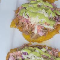 Tostones Beef · Shredded beef, coleslaw, cheese,  and our sauce