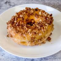 Cinnamon Crumble - Raised Donut · Crumbled cake donuts mixed with cinnamon and sugar on top of vanilla icing