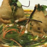 Vegetable Samosa · 2 crisp and spiced vegetable puffs filled with potatoes and peas.