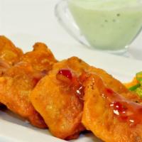 Fish Pakora · Juicy salmon dipped in spiced chickpea batter. Served with homemade mint chutney, hot and so...