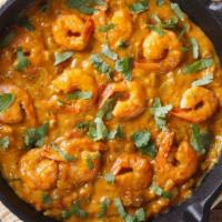 Shrimp Korma · Black tiger shrimp cooked in a rich creamy sauce and garnished with cashew and raisins.