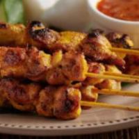 satay chicken · grilled sliced chicken on sticks.  served with peanut sauce and cucumber salad.