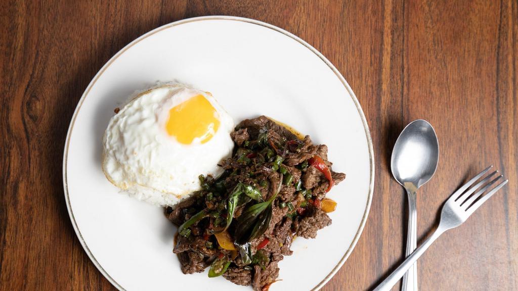 Basli beef over rice + Fried egg (Pad Kra prow nuer +Khai Dao) · Sauteed sliced beef, Thai basil, Thai chili, garlic, bell pepper, long bean with white jasmine rice topped with fried egg.