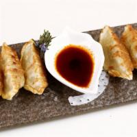 Gyoza · Choice of chicken, seafood, pork or vegetable dumplings served with chili vinegar.