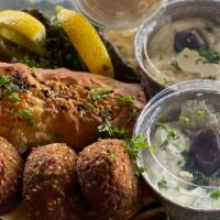 Moussaka Meze · Combination meze plate of 3 dolmades, 3 falafel, 1 spanakopita, hummus, tzatziki served with...