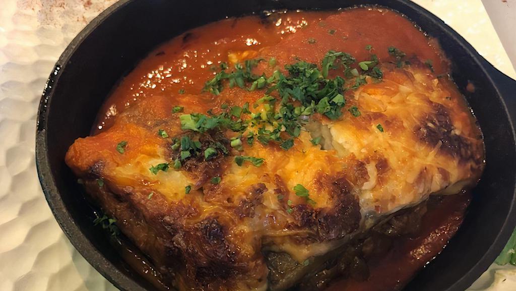 Meat Moussaka · Grilled eggplant, meat sauce, mozzarella cheese, bechamel sauce, served w/rice with orzo