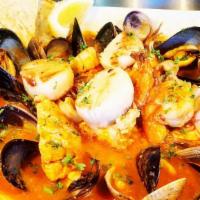 Bouilabaisse · Clams, mussels, grilled salmon, prawns, calamari, scallops, in a tomato saffron broth served...