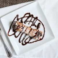 Cannoli · Crunchy pastry shell stuffed with sweetened ricotta cheese filling, festooned with chocolate...