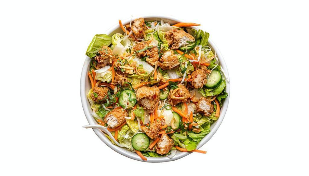 Thai Chicken Salad · Sweet Thai Crispy Tenders, cucumbers, carrots, Asian herb mix, crispy shallots, toasted sesame seeds, green papaya dressing drizzle, Spicy Herb Aioli