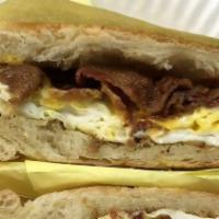 Bacon, Ham & Egg Breakfast Sandwich · Bacon, ham, egg, and cheese on croissant.