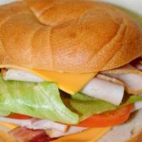 Turkey Sandwich · Cheese, mayonnaise, mustard, lettuce, tomato, onion and pickles. Served with choice of bread.