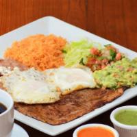 Huevos Con Bistec · Two eggs with grilled steak. served with rice, refried beans, lettuce, pico de gallo, and an...