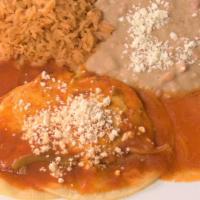 Huevos Rancheros · Two eggs with corn tortillas marinated in red sauce topped with fresh cheese. served with re...