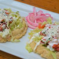 Sope · Fried masa topped with refried beans, your choice of meat, beans, lettuce, pico de gallo, fr...