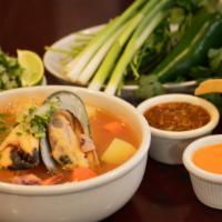 Caldo De 7 Mares · Savoury tomato soup with clams, fish, octupus, shrimp, calamari, crab legs, potatoes, and ca...