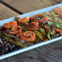 Bistec, Camarones Y Nopales · Shrimp and grilled steak sautéed with a spicy diablo sauce, served with cactus, black beans,...