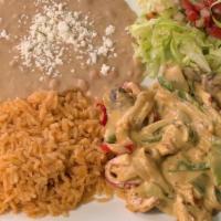 Pollo Con Crema · Chicken breast mixed with a cheesy cream sauce mushrooms, onions, and bell peppers. served w...