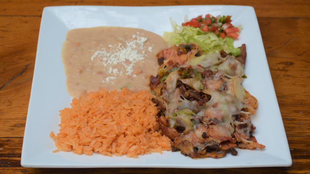 Alambre · Steak, chorizo, bacon, onions, bell peppers, and mushrooms topped with melted cheese. Served with rice, refried beans, and an order of tortillas.