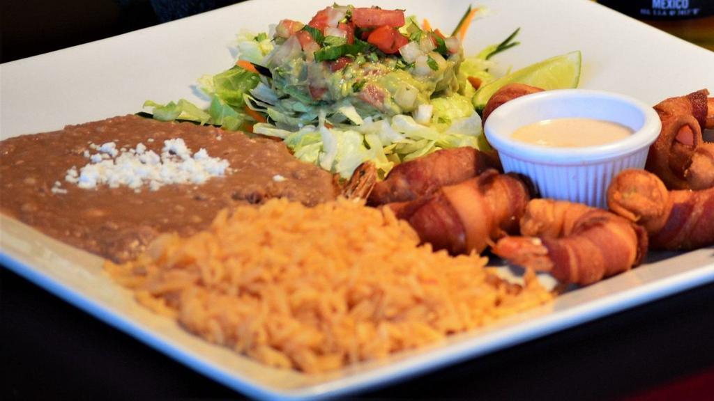 Camarones Con Tocino · Shrimp wrapped in crispy bacon with a side of creamy aioli sauce. Served with rice, refried beans, tortillas and pico de gallo.