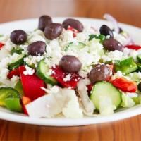 Greek Salad · Dressed with olive oil, lemon , Greek oregano and a touch of vinegar .   Topped with Greek F...