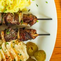 Shish Kabob Lamb Plate · Boneless Lamb skewered and grilled Lebanese style .  Served with Hummus, Mediterranean salad...