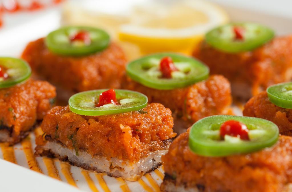 Crispy Rice With Spicy Tuna  (1.2.) · Spicy tuna over a layer of crispy rice & spicy aioli topped with jalapenos & sriracha