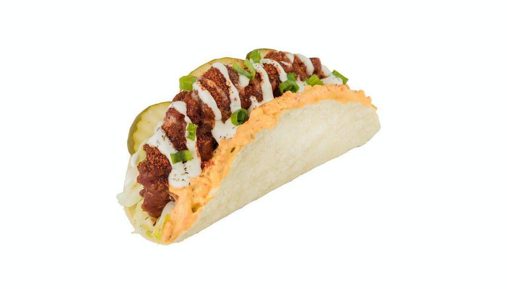 Nashville Hotbird® Taco · Nashville Hot Crispy Chicken, classic slaw, pimento cheese, dill pickles, Greek Yogurt Ranch, green onions