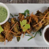 Mix Vegetable Pakora · Potato, onions, cabbage, and  spinach coated in a chickpea batter and fried