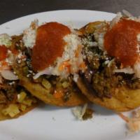 Enchiladas salvadoreñas · Fried tortilla with beans, ground beef, carrots, potato, green beans, curtido, salsa, cheese...
