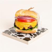 Cheeseburger Slider · Juicy beef patty with melted cheddar cheese, lettuce, tomato, onion, pickles, and mayo on a ...