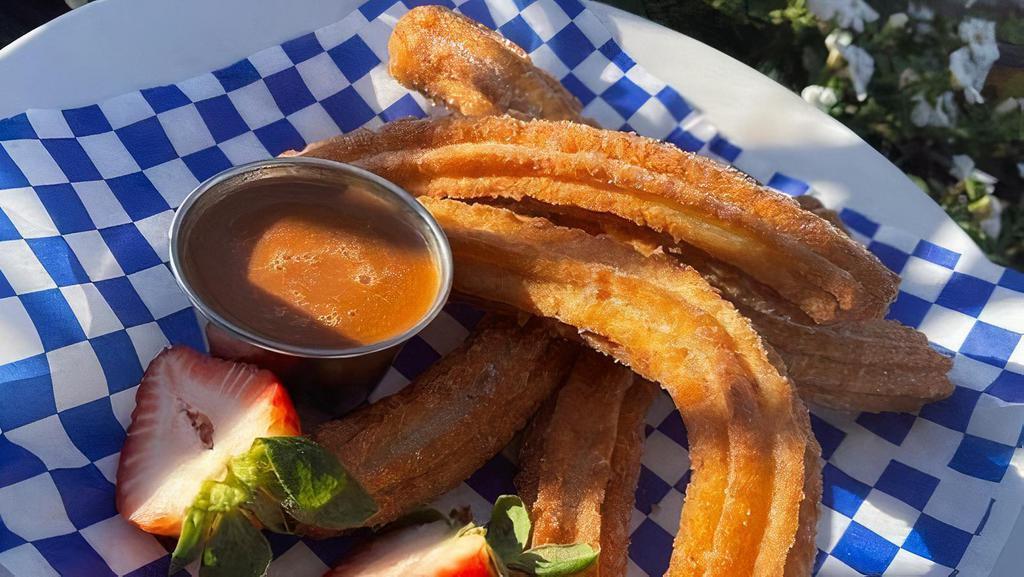 Churros · Six Churro Pieces Served With a Dulce de Leche Dipping Sauce.
