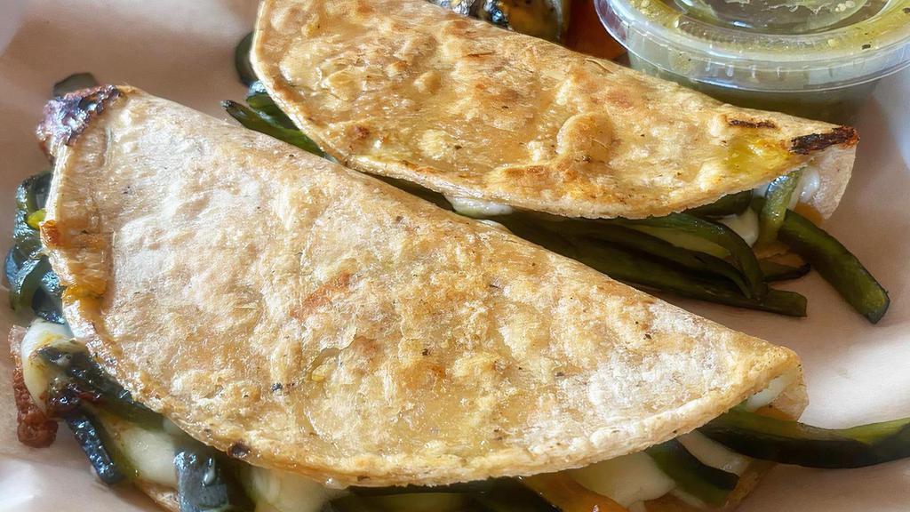 Quesadilla de Rajas · Two Yellow Corn Oaxaca Cheese Quesadillas Stuffed with Marinated Poblano Peppers.